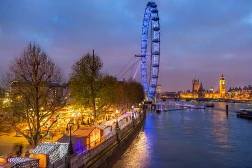 Christmas market on the southbank of the Thames at nighttime.