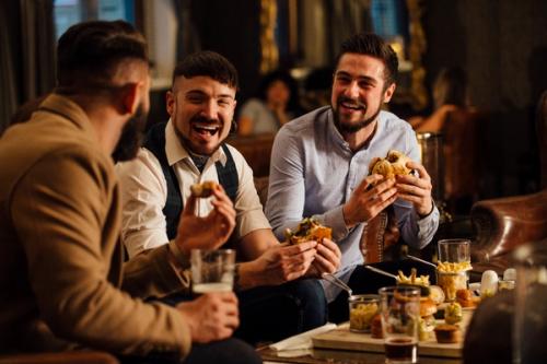 Group of men eating at Restaurant