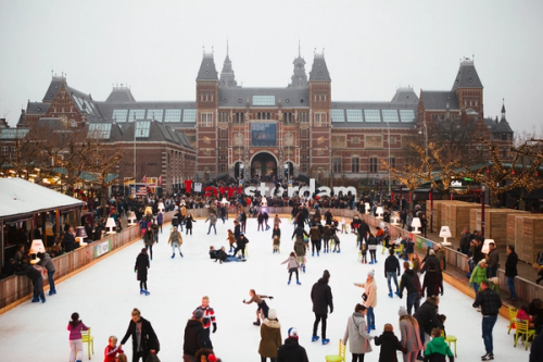 People ice skating in Amsterdam at Christmas.