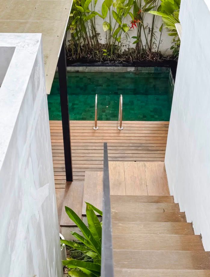 Timber stairs leading down to the pool and deck