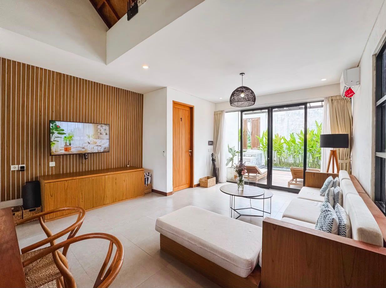 Living and dining space under the vaulted timber ceiling