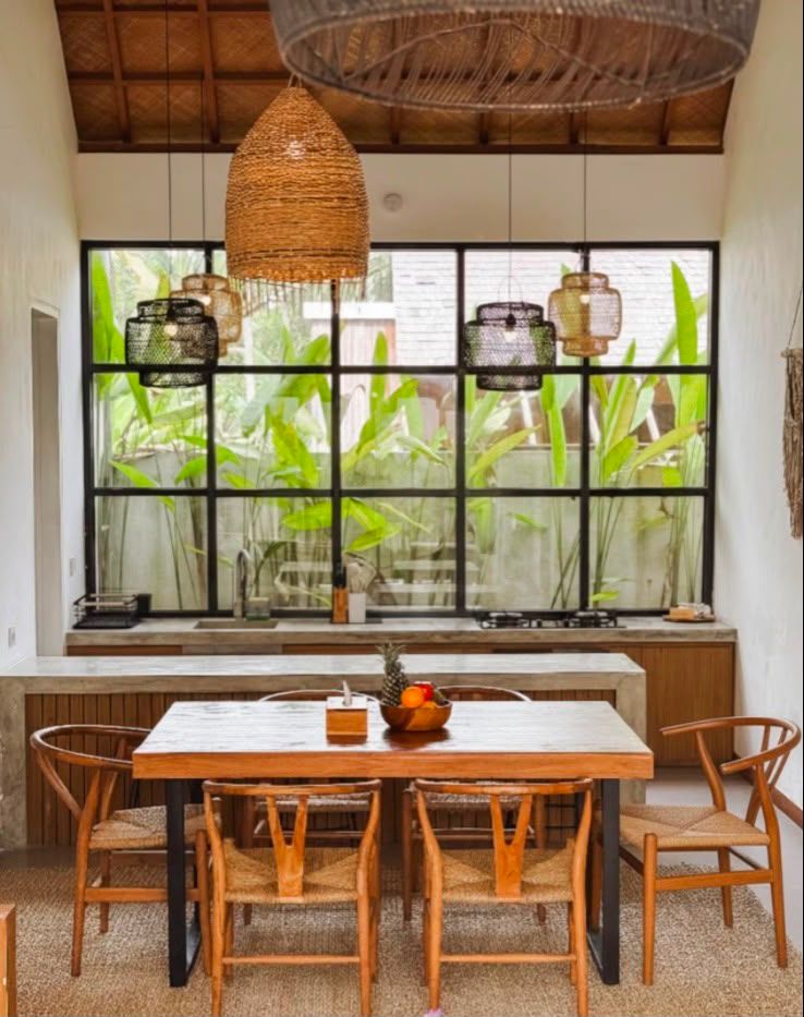 Kitchen and dining area with concrete counters and steel-framed garden window