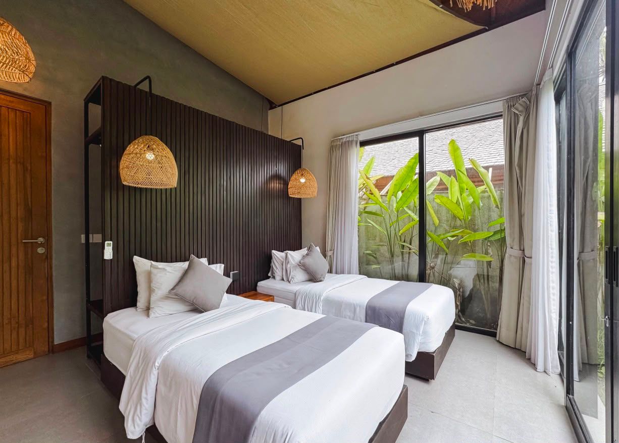 Bedroom with timber-slat feature wall opening onto a private courtyard