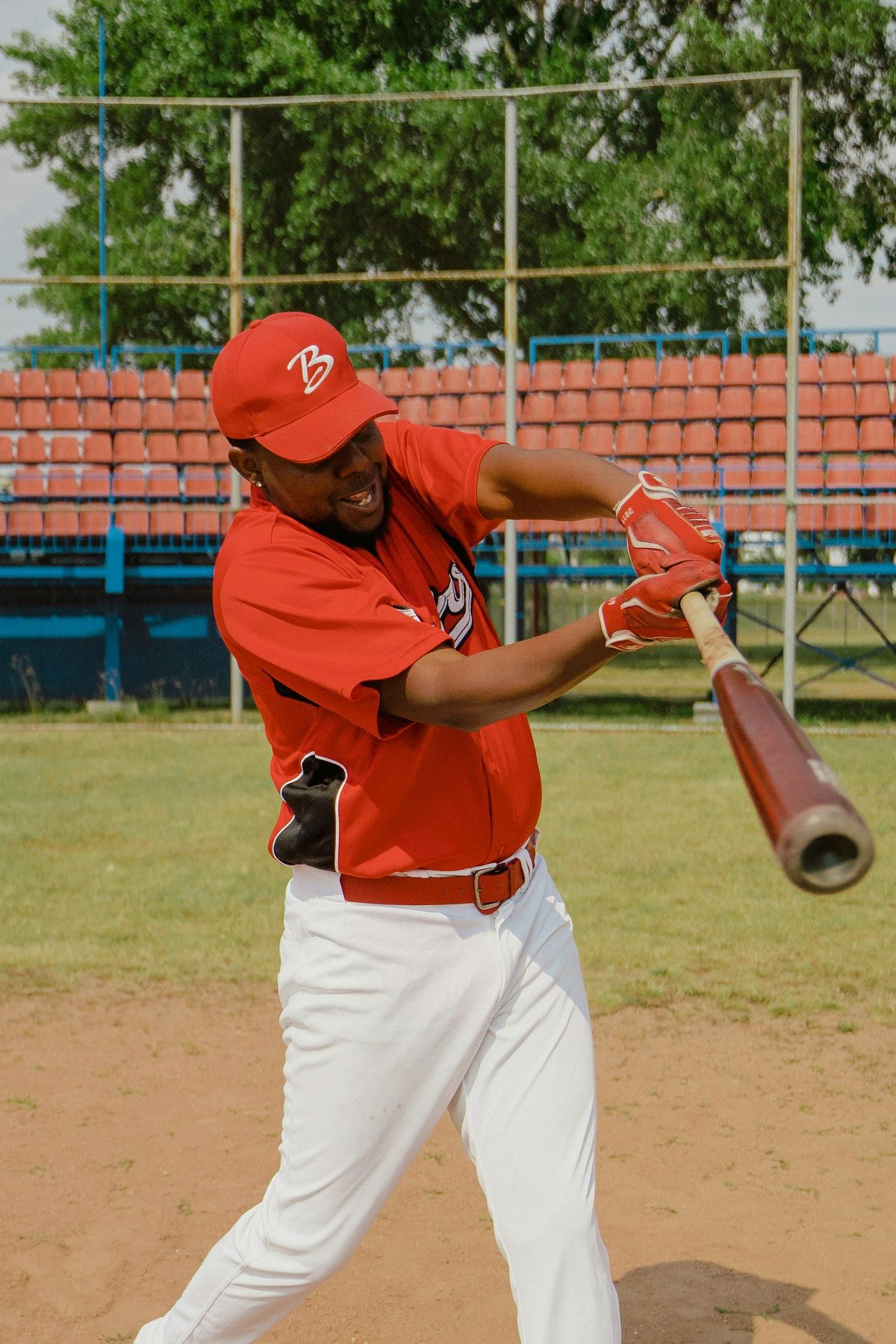Player taking batting practice in a cage