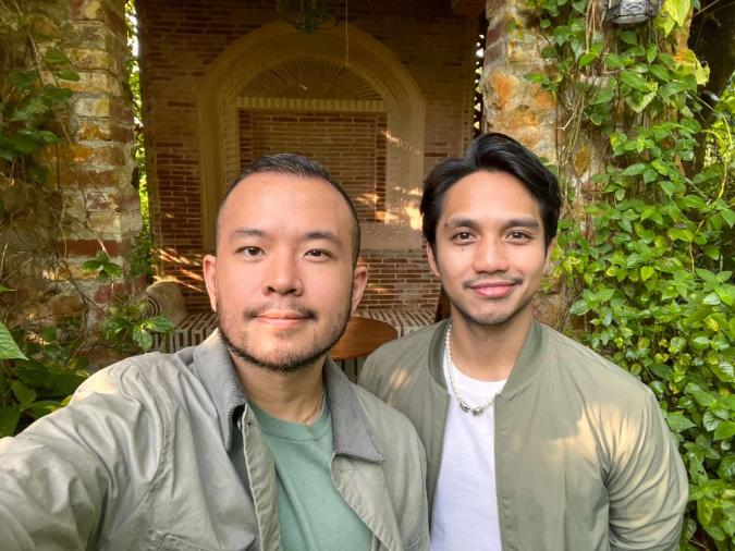 Two men in khaki attire smiling to the camera