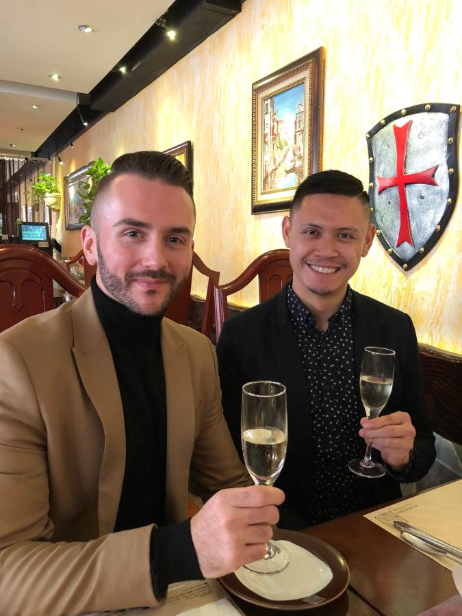 Two men holding a champagne glass