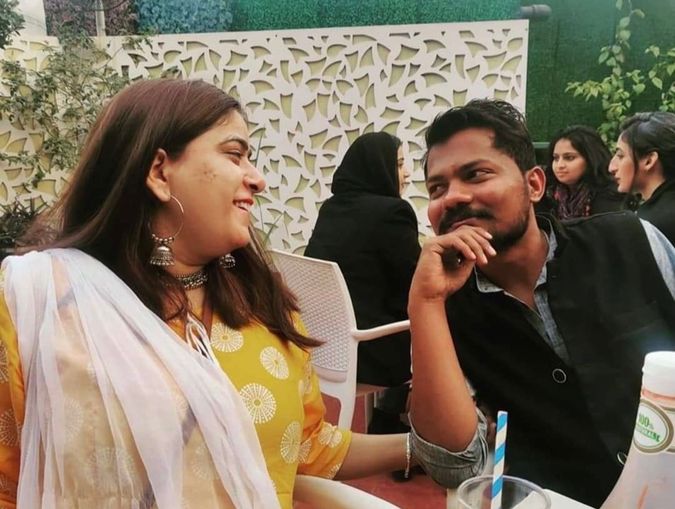 An inter-caste couple smiling and staring at each other