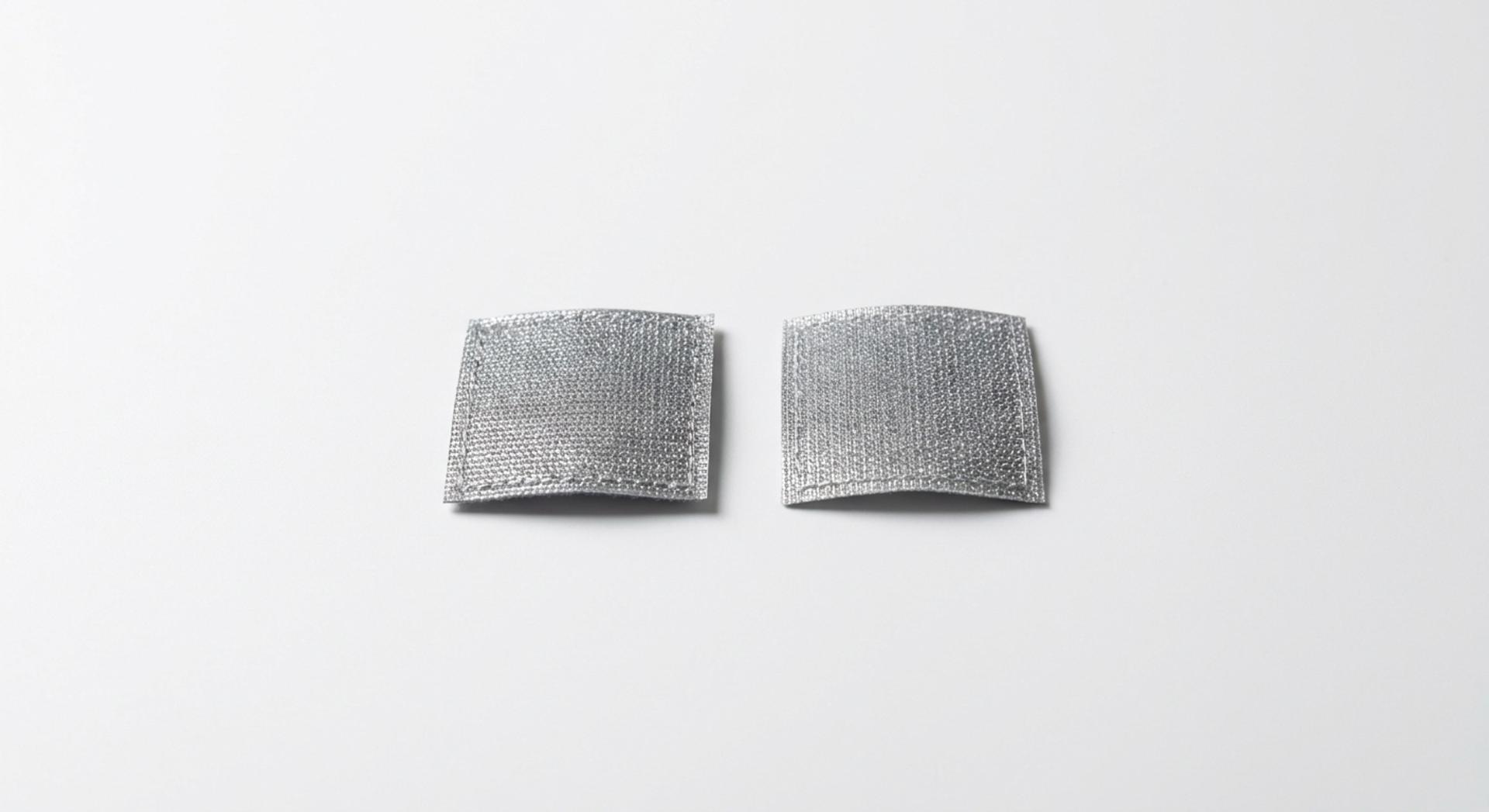 Silver reflective patches on a white background.