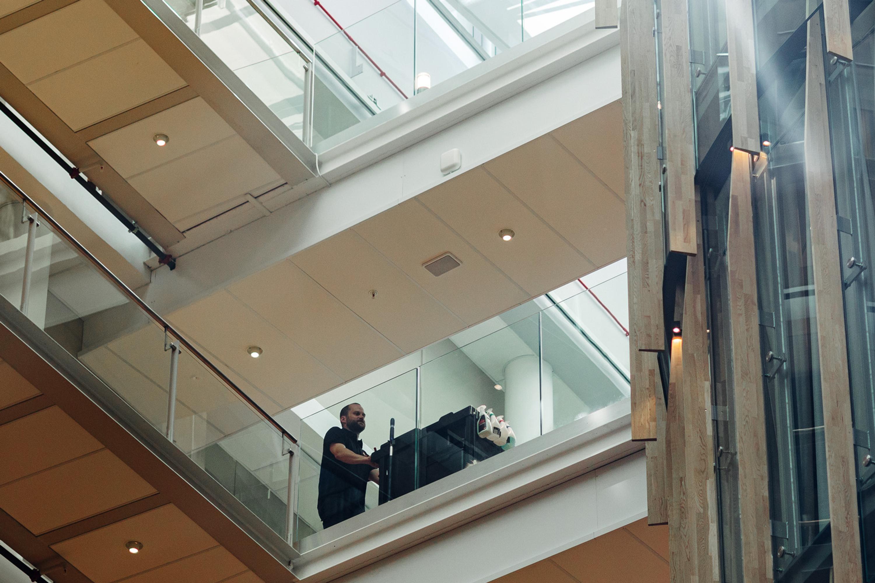 Cleaning worker pushing trolley