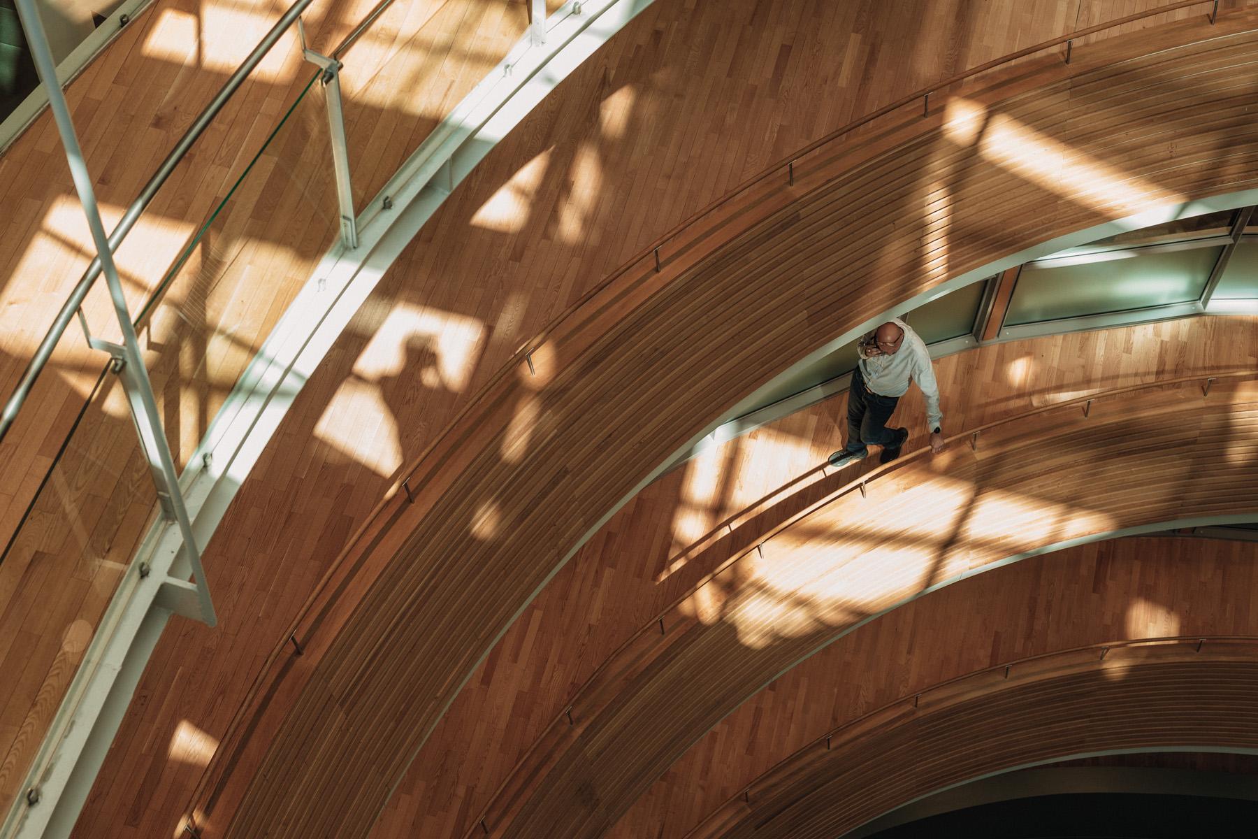 Man walking and holding a railing