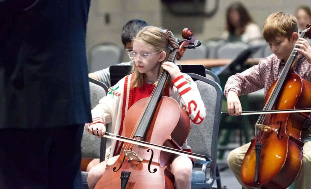 A young cellist performs with the orchestra during a Saint Stephen's concert.