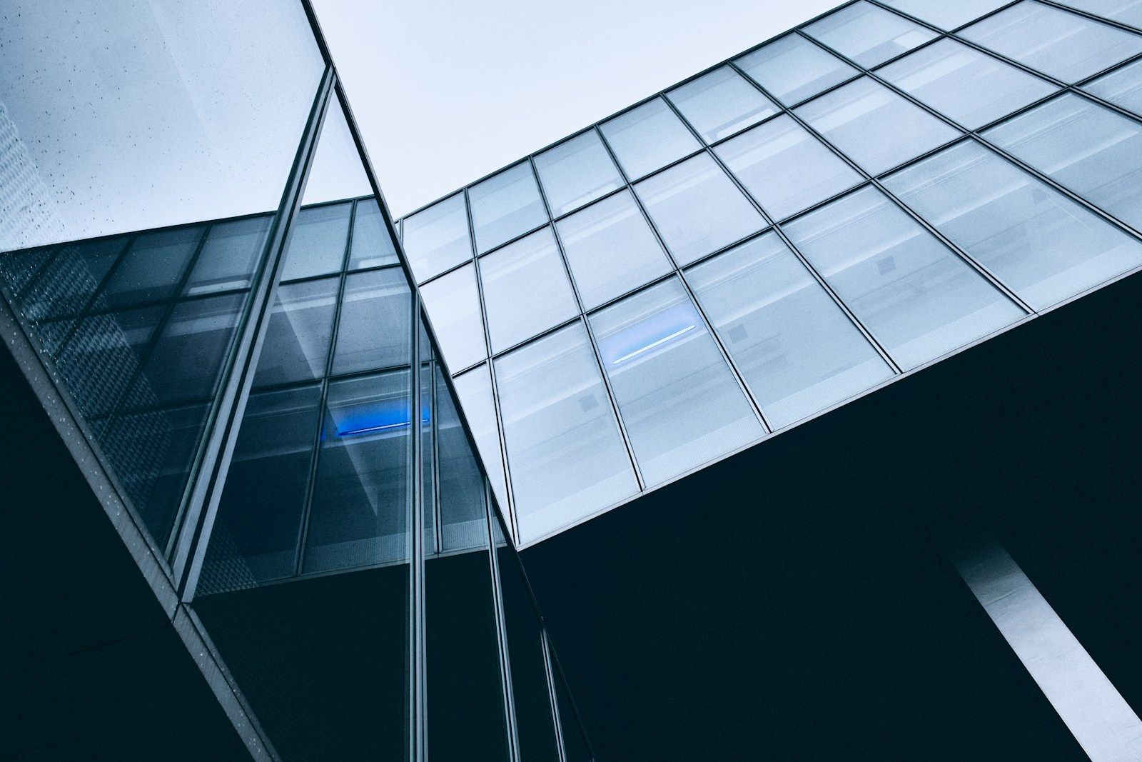 A glass office tower reflecting the sky