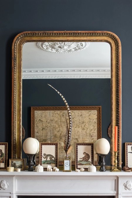 An image of a mirror above a fireplace
