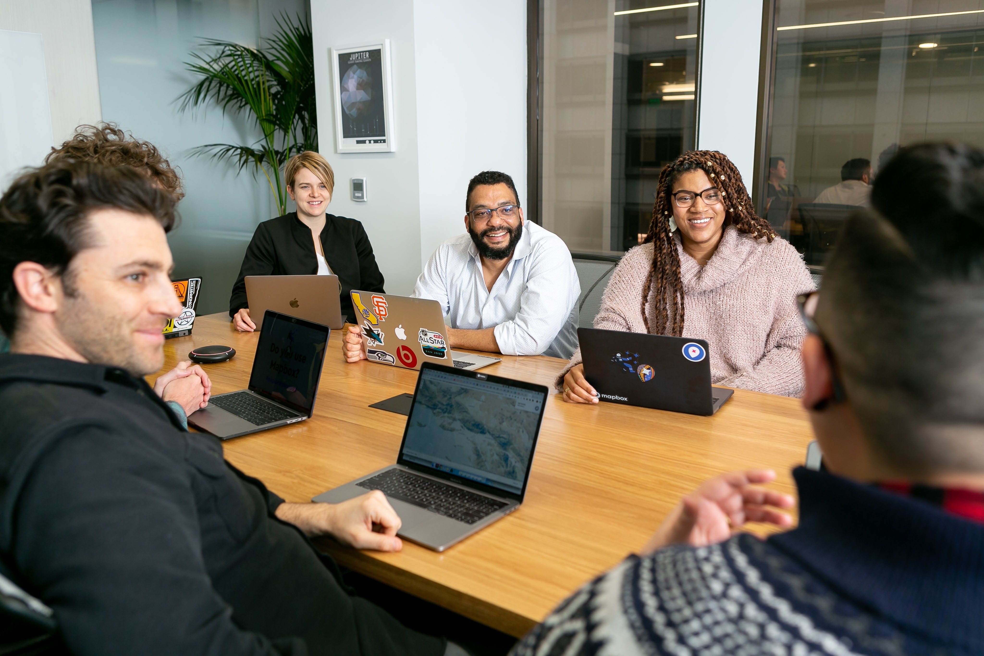 Photo of diverse team working together in meeting room