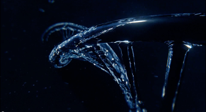 Black background, with watery CG effect in the basic shape of DNA.