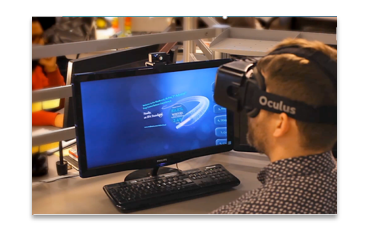 Man in the INVIVO office wearing Oculus headset while a 3D animated medical procedure is shown on the monitor.