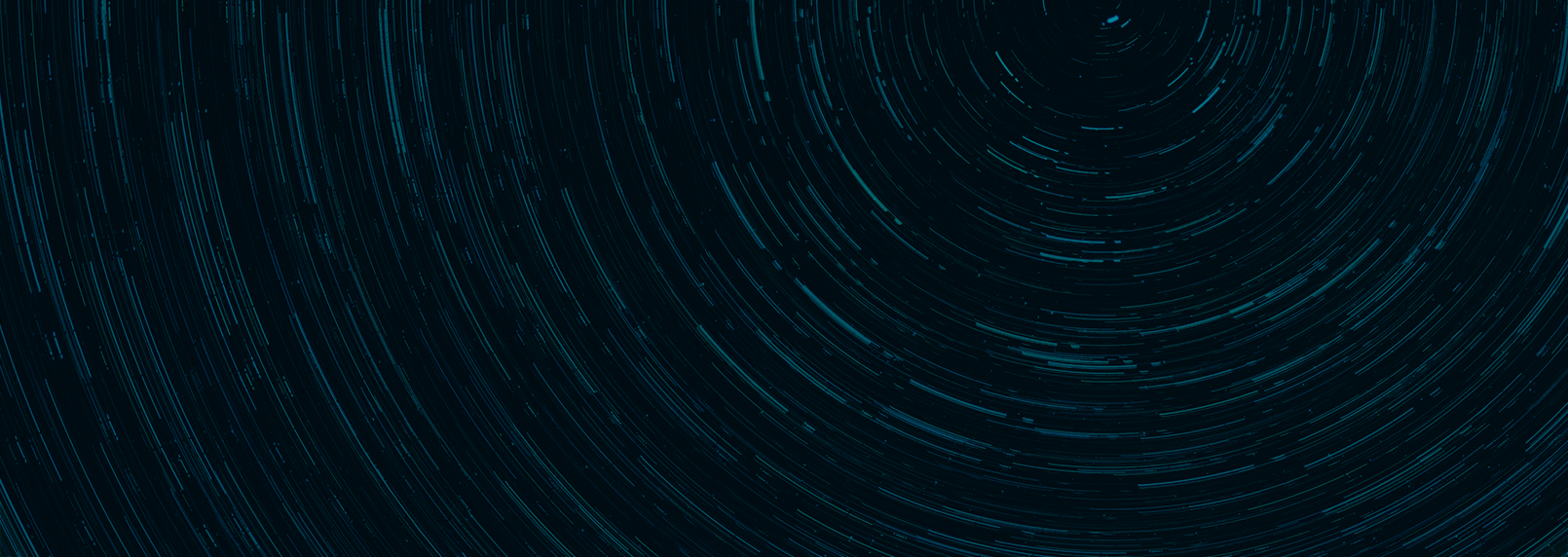 A dark background with teal tinted streaks like stars in a time lapse around a focal point near the top right.