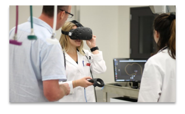 A woman wears VR goggles in a lab setting with other people in white coats.