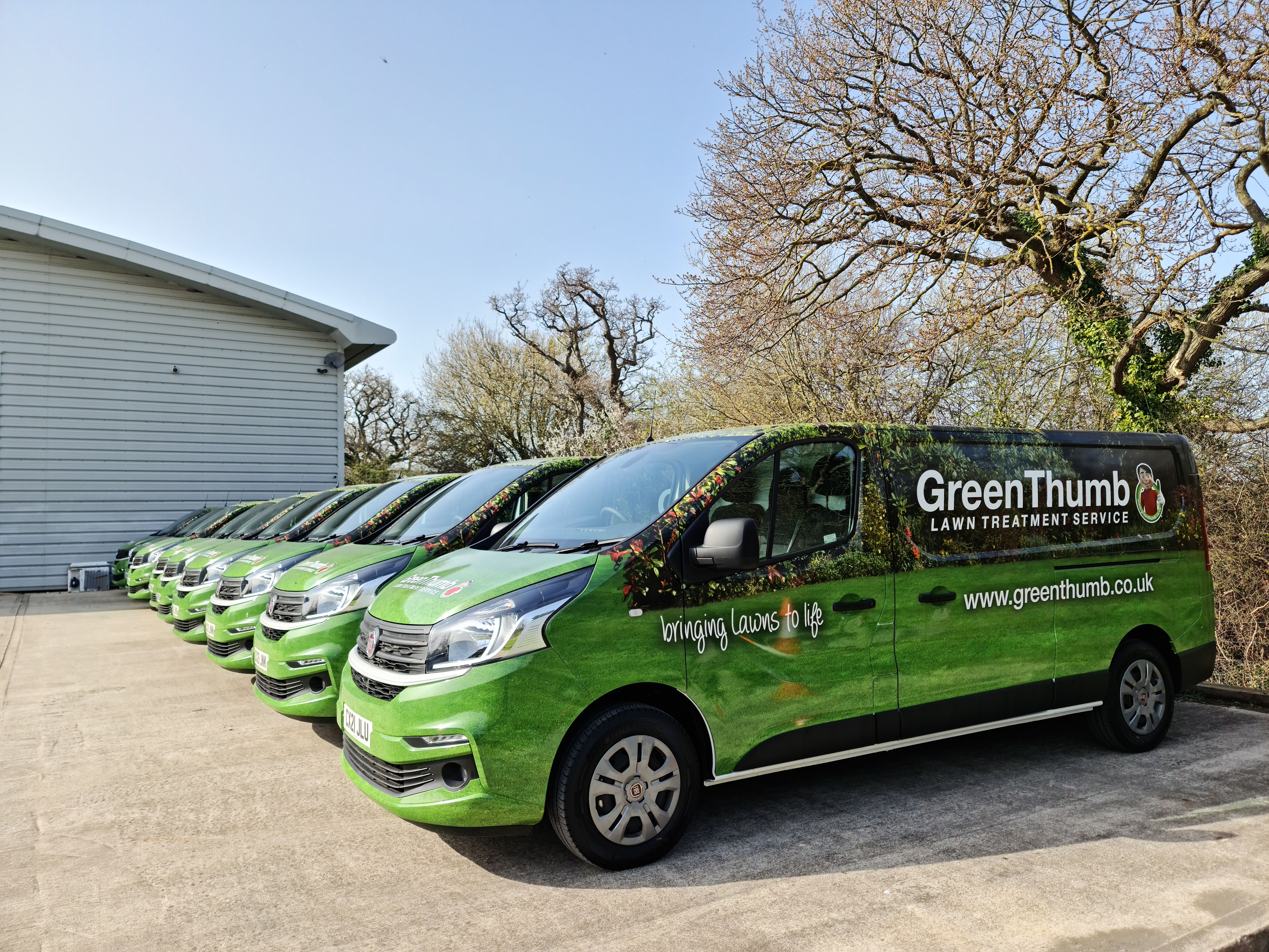 GreenThumb vans lined up in a car park 