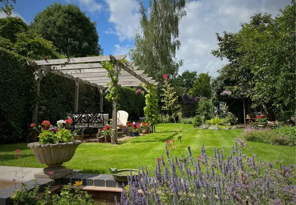 GreenThumb lawn expert applying a core treatment to reduce weeds and moss, helping keep the lawn healthy, hydrated and lush