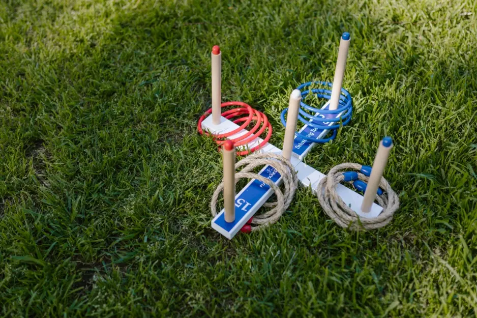 Children playing garden games on a lush green lawn during summer