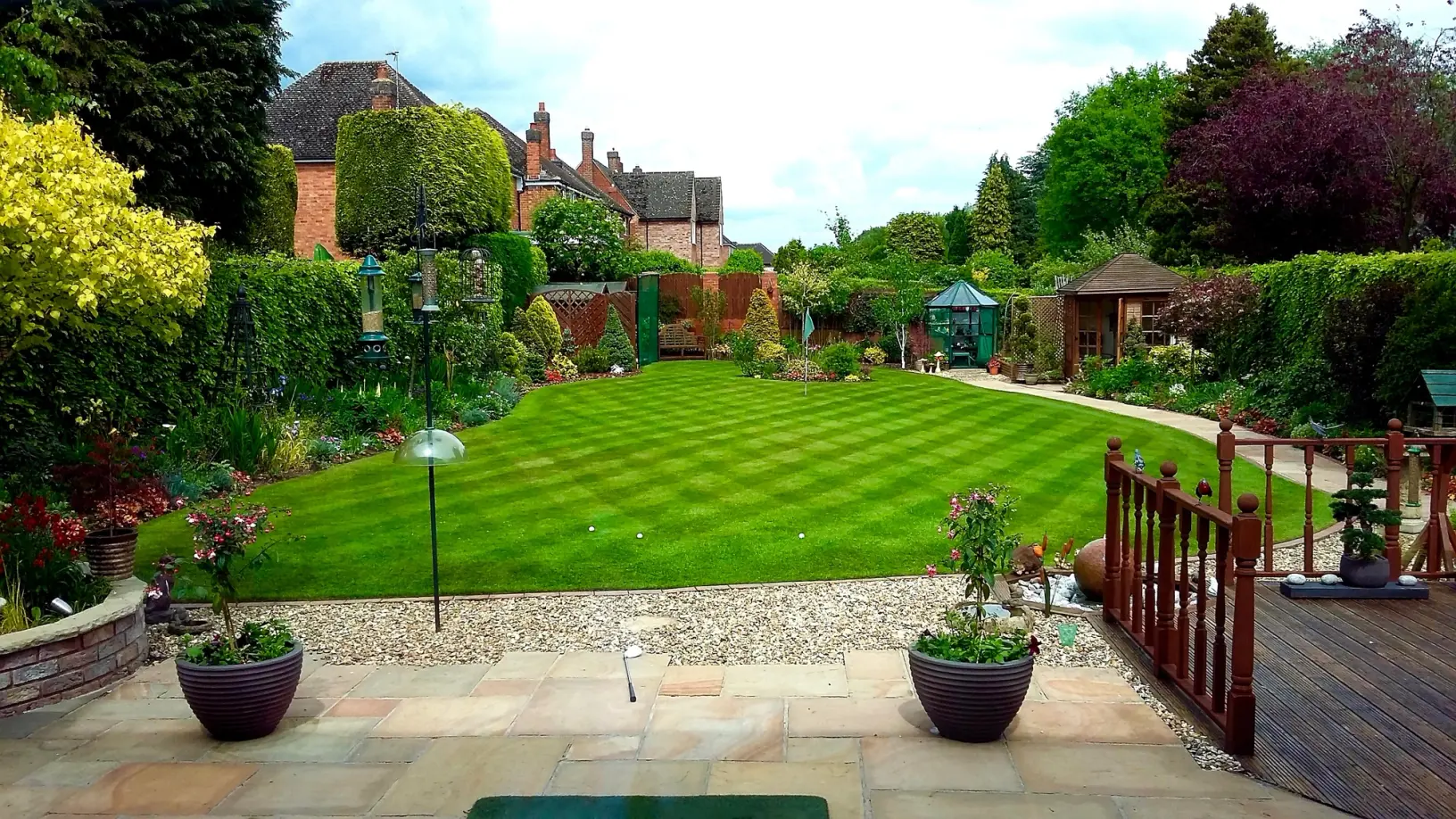 A well-kept garden lawn used as the hero banner image for the GreenThumb Customer Portal.