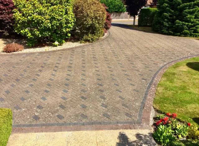 Driveway before GreenThumb Hard Surface Treatment, showing dirt build-up and weathered paving.