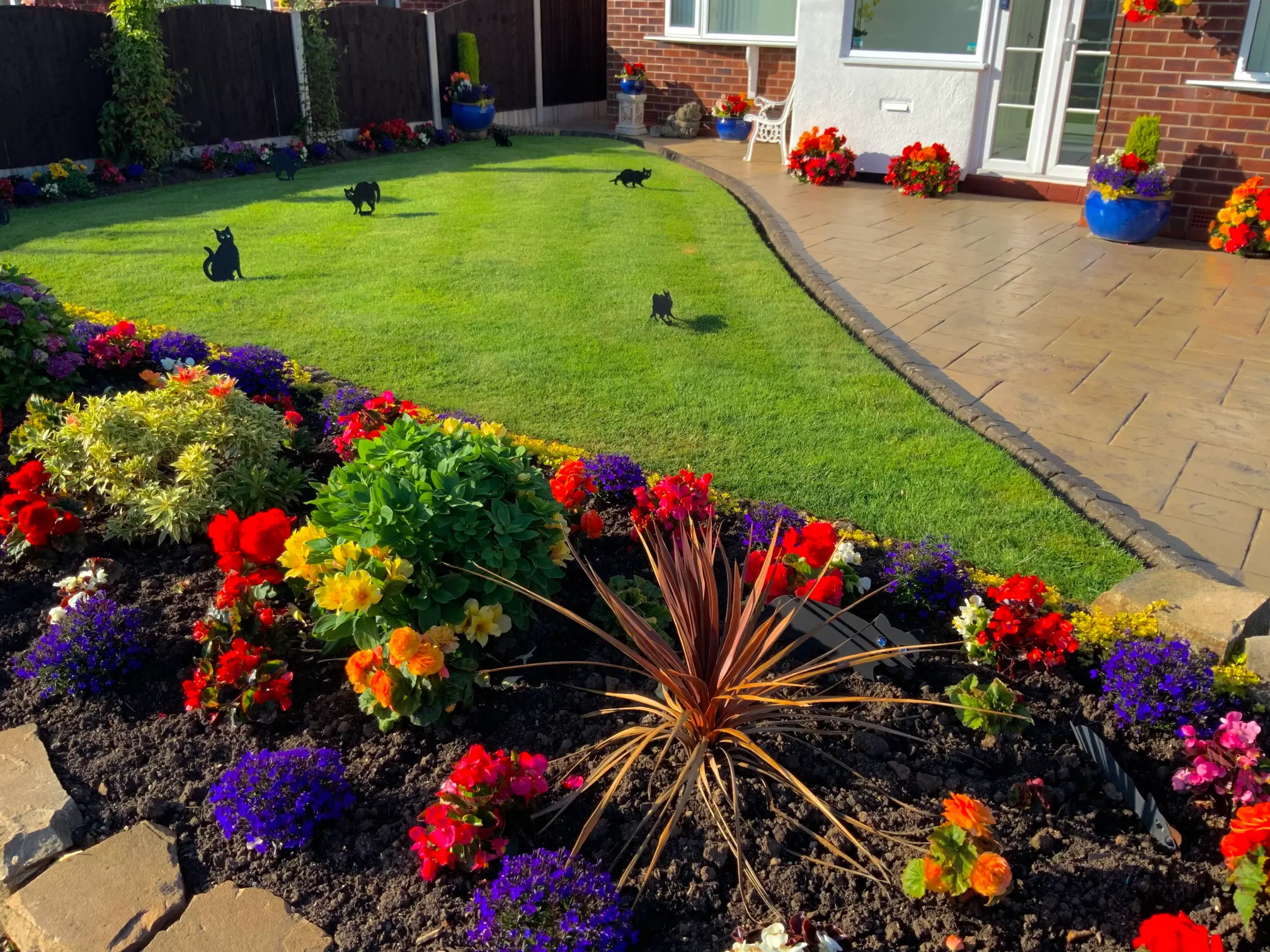 Green Lawn treated by GreenThumb with colourful flower border
