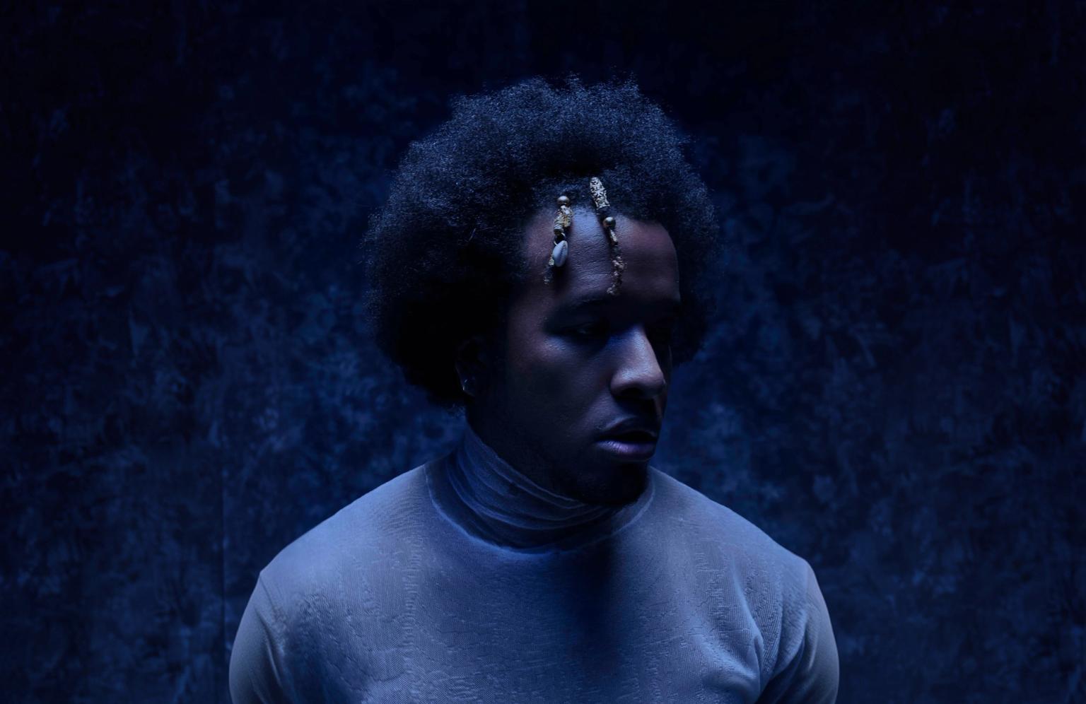 Cautious Clay – Artist press photo in dramatic blue lighting