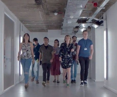 Group of people walking through a hallway