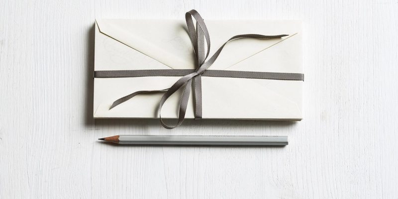 Envelope with bow and pencil