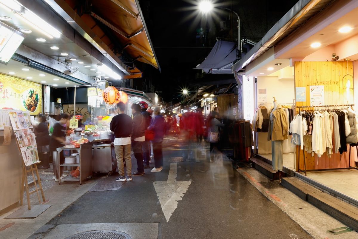 Evening street food stalls and shops in the Shida night market area