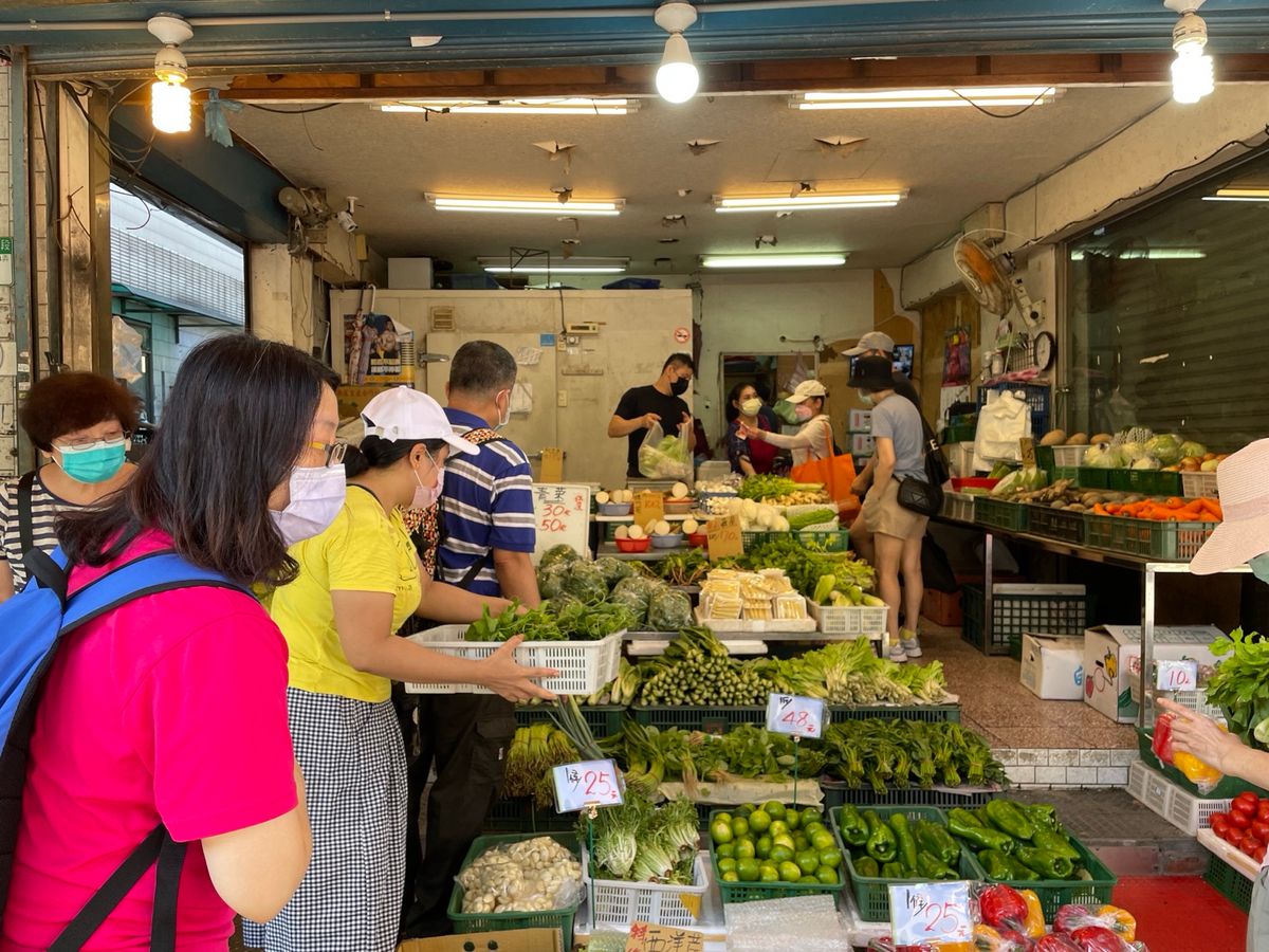 A busy greengrocer stall in a traditional wet market in Taipei