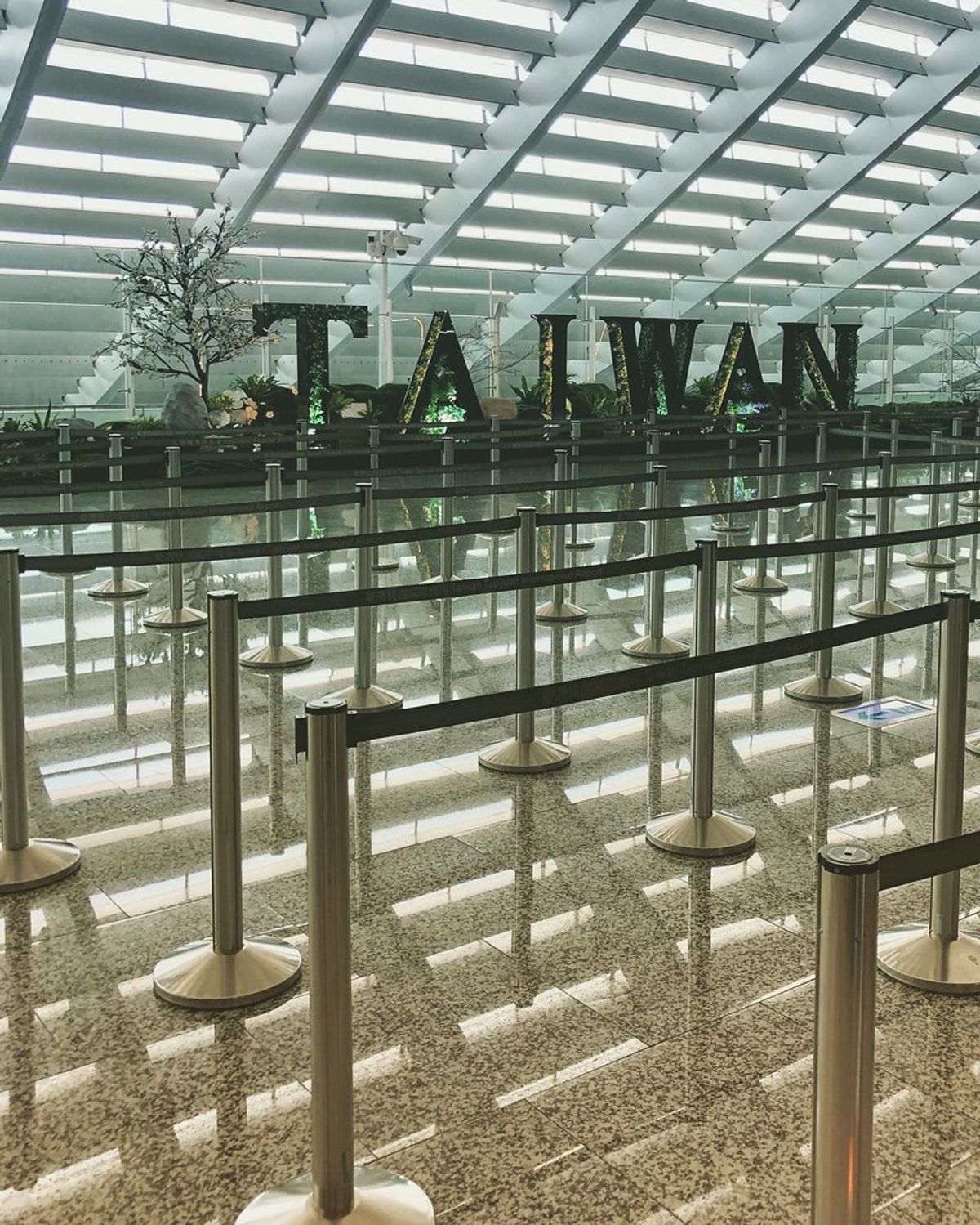 Empty arrival queue lanes and a TAIWAN sign at the airport in Taipei
