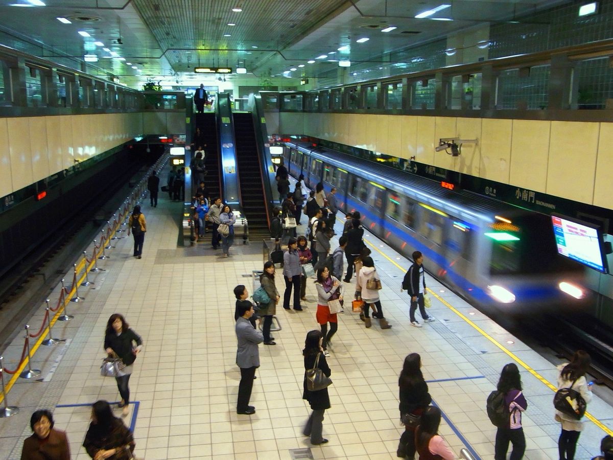 Commuters waiting on the platform at Xiaonanmen Station on the Taipei Metro
