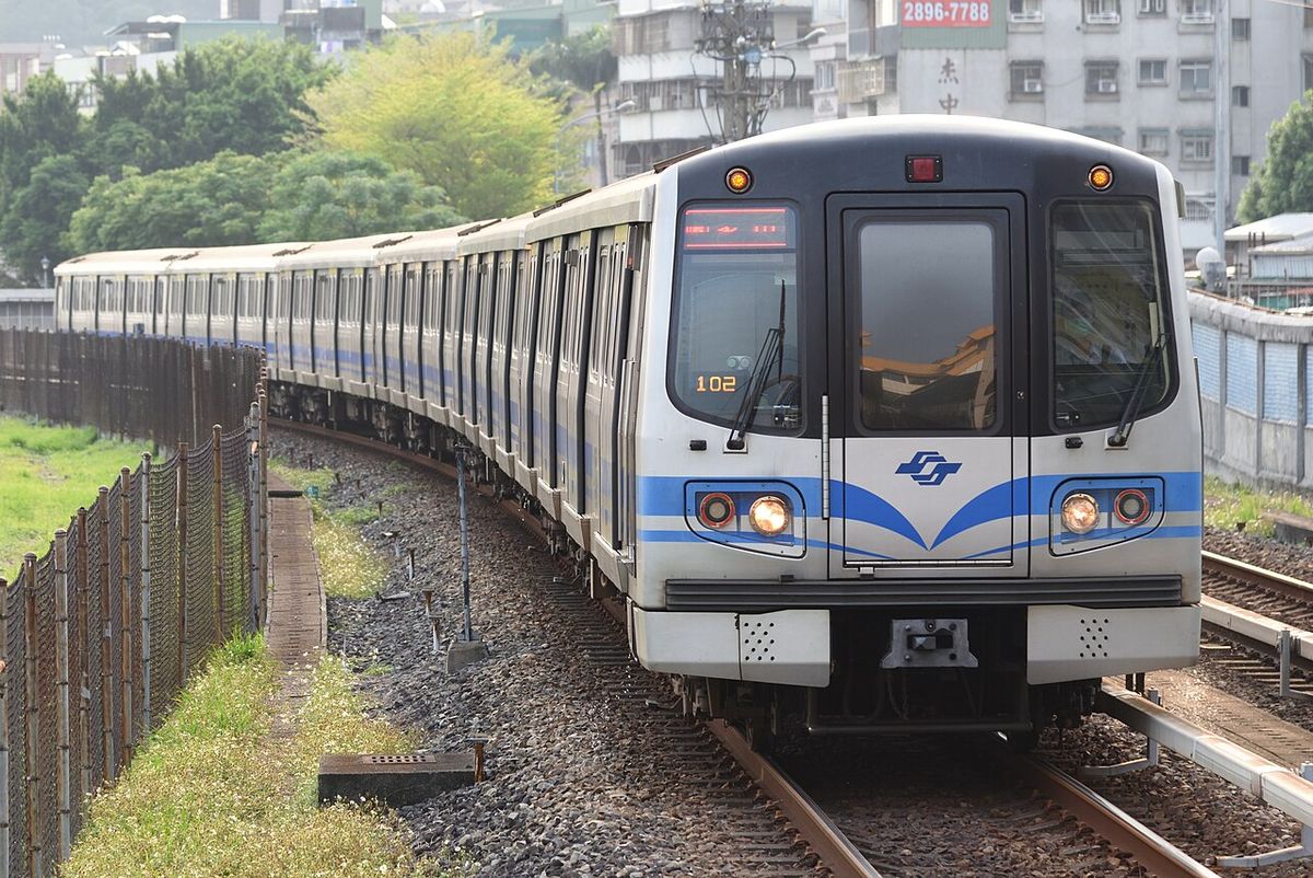 A Taipei Metro train arriving at an elevated station on the Red line