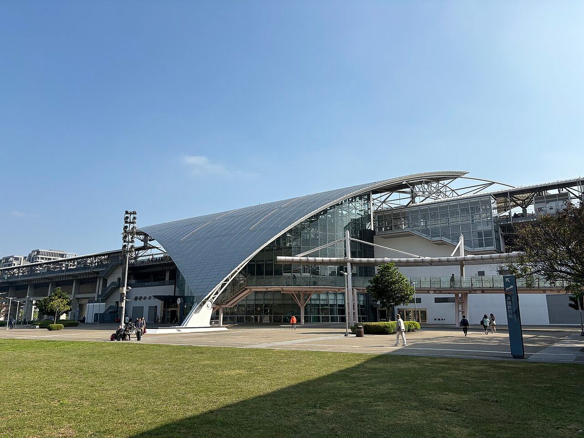 The curved glass and steel roof of THSR Hsinchu Station in Zhubei on a clear day