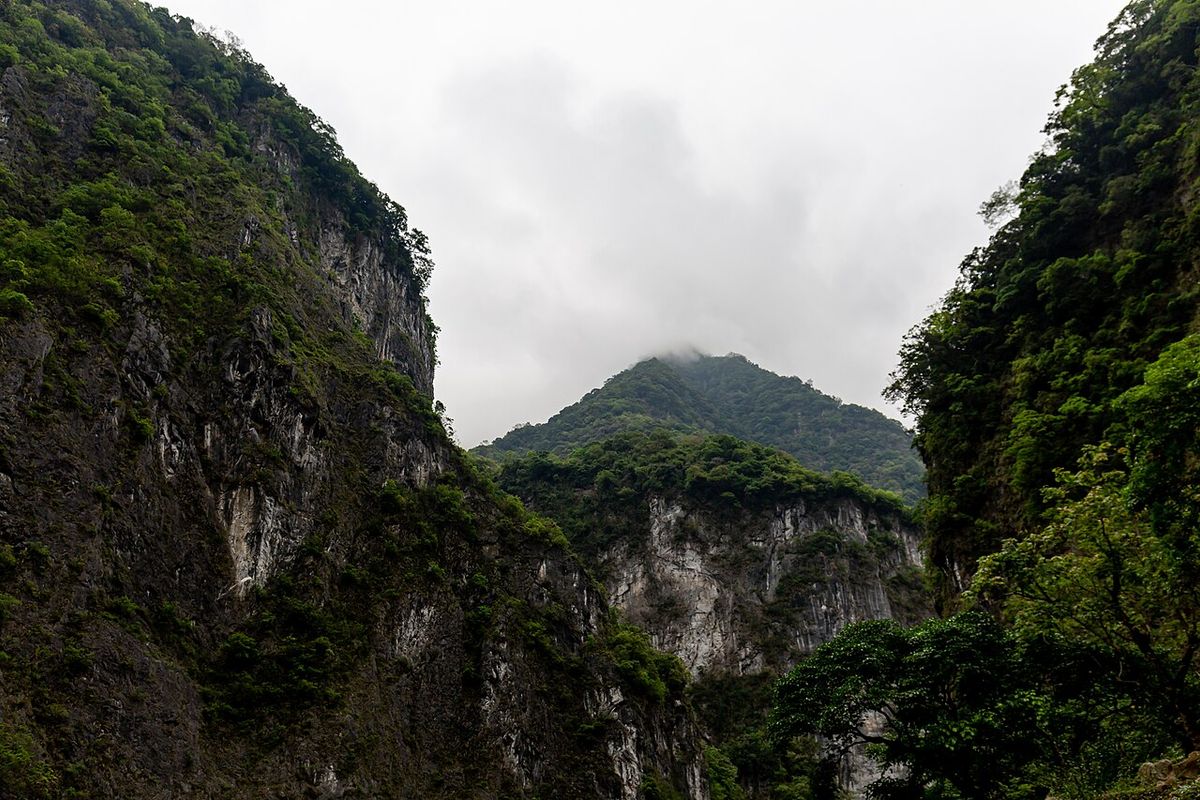 Steep forested cliffs of Taroko Gorge under low cloud