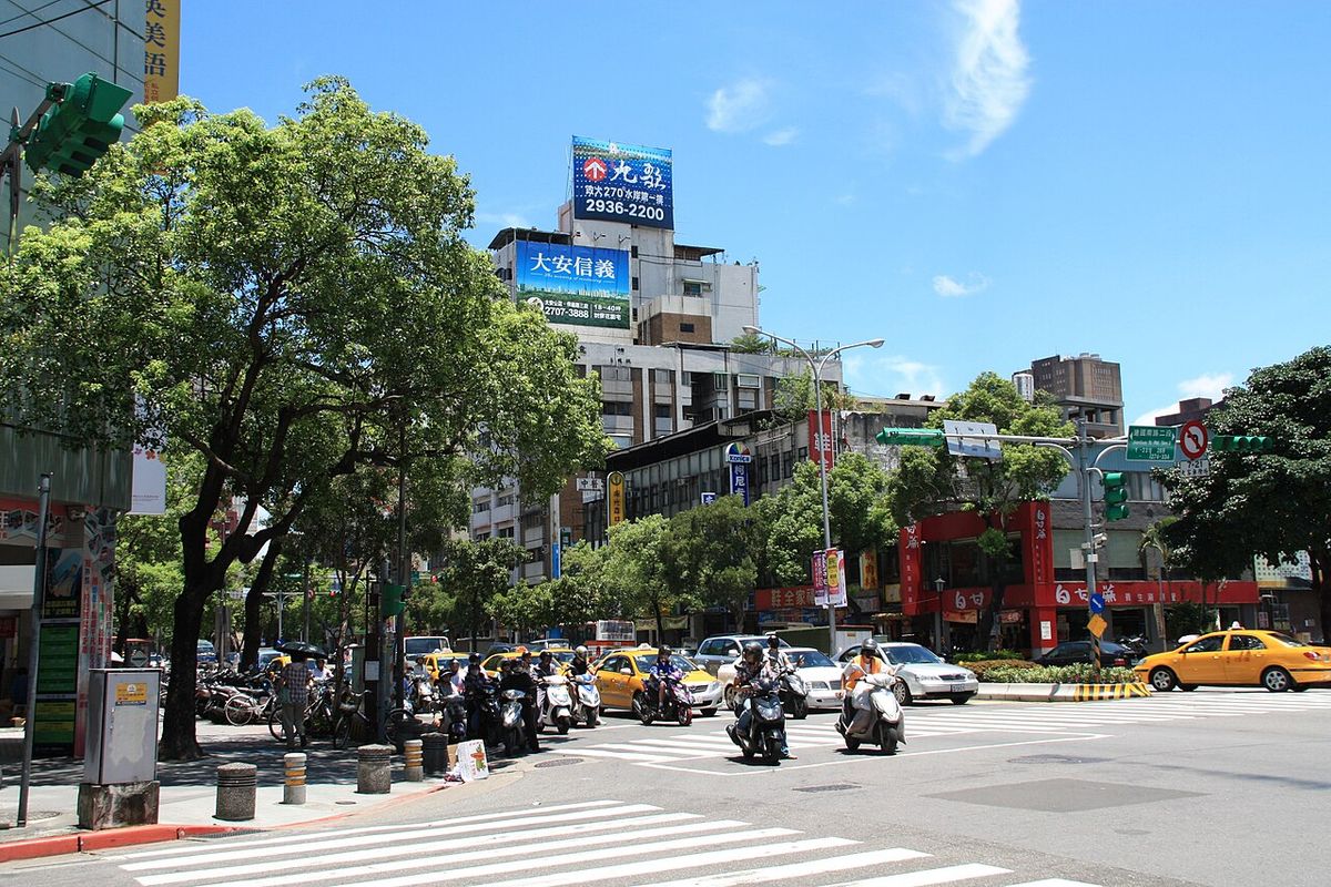 Scooters waiting at a crosswalk at the Heping East Road and Jianguo South Road intersection in Da'an, Taipei