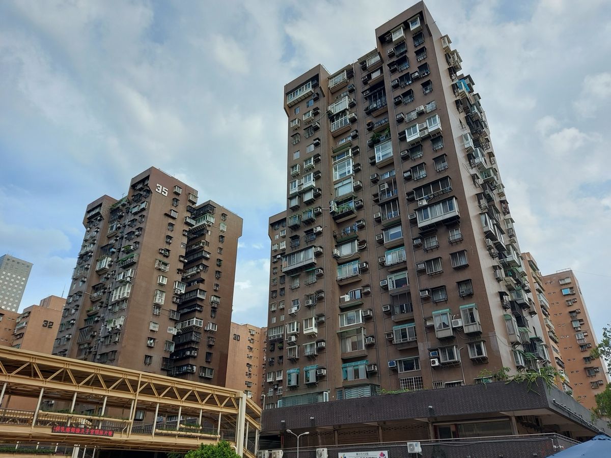 Tall apartment towers in Taipei under a cloudy sky