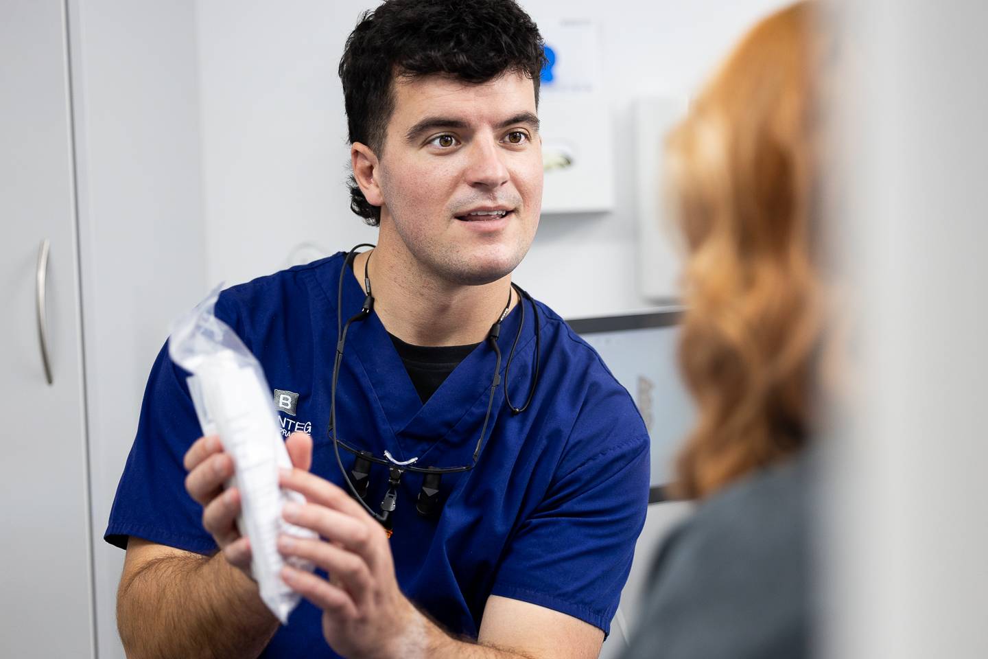 Dentist explaining dermal filler treatment