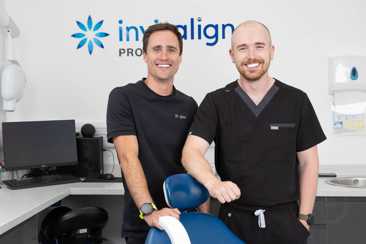 Two dentists smiling in a modern dental surgery