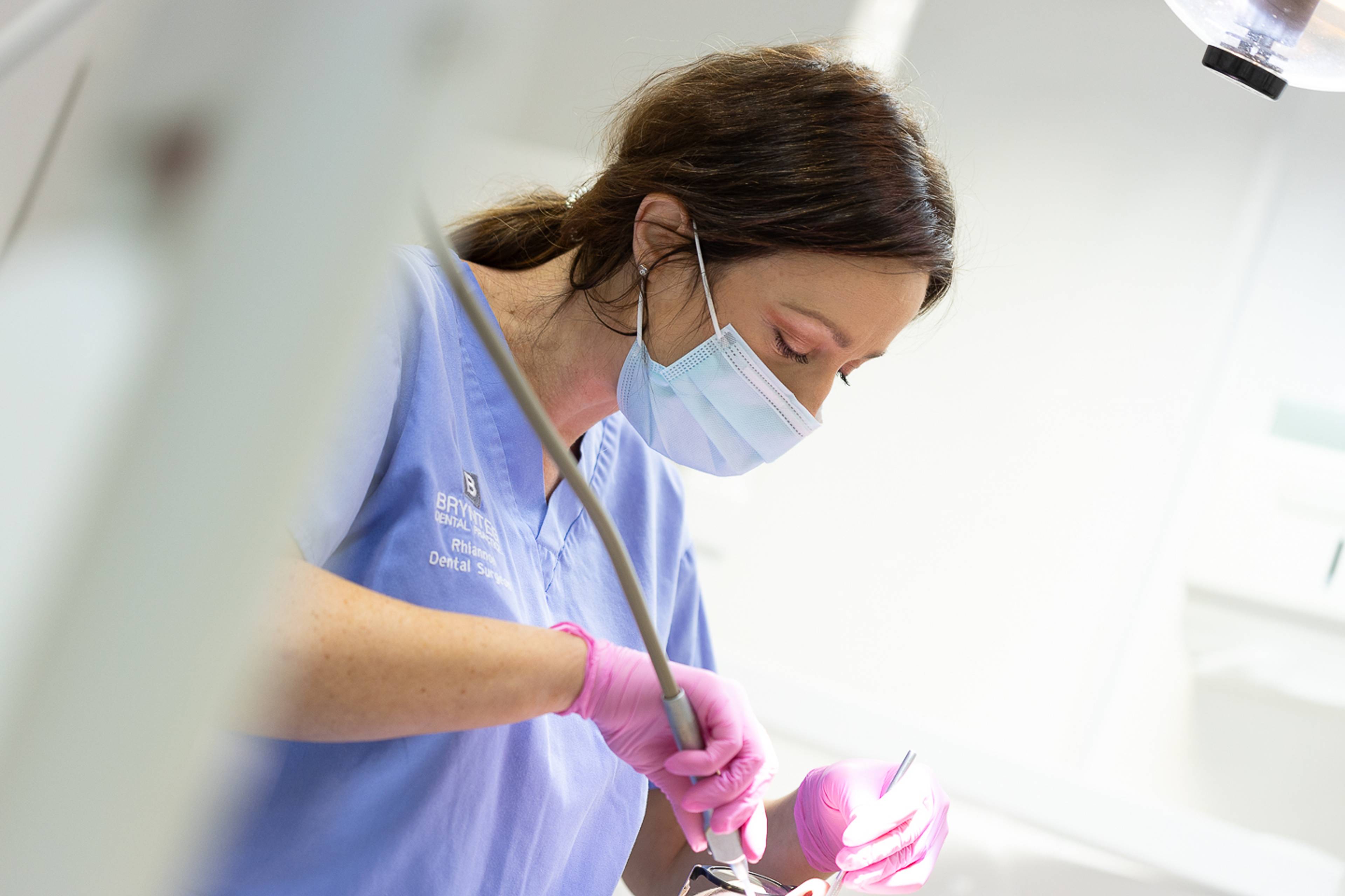 Dentist performing oral surgery