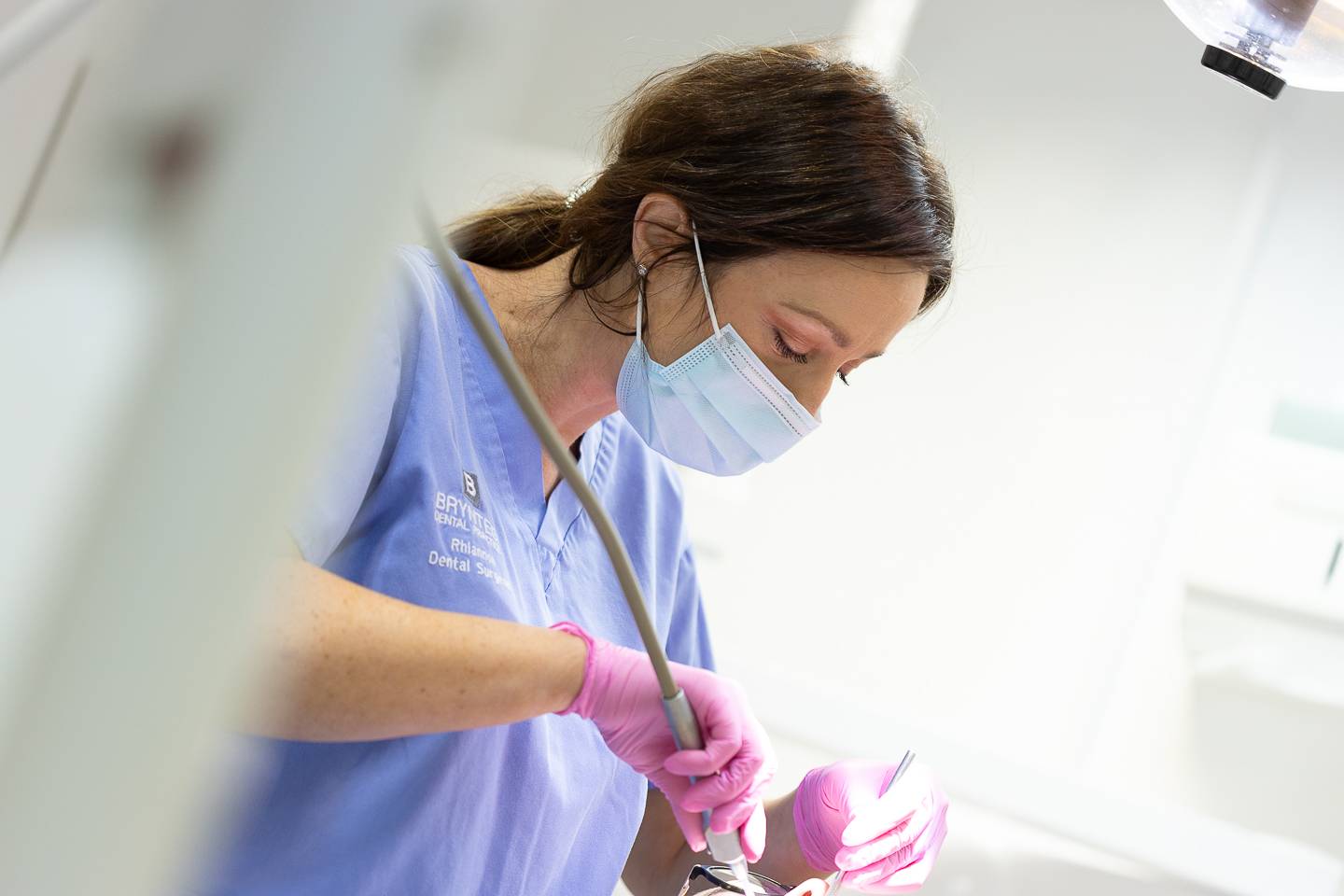 Dentist performing oral surgery