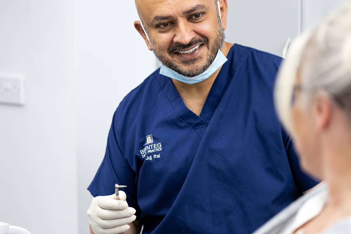 Friendly dentist with patient at Brynteg Dental