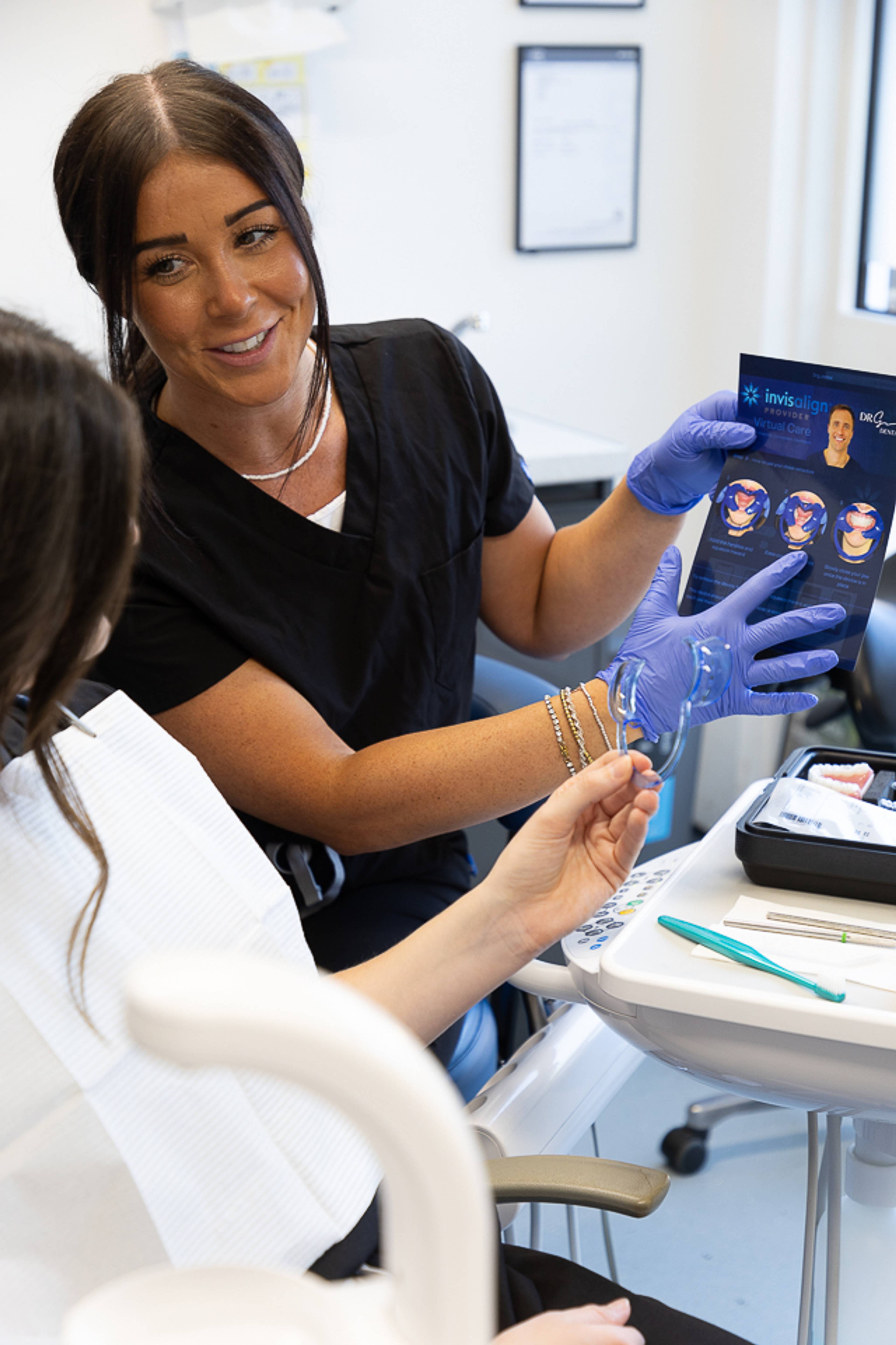 Dental nurse showing patient information leaflet about Invisalign treatment