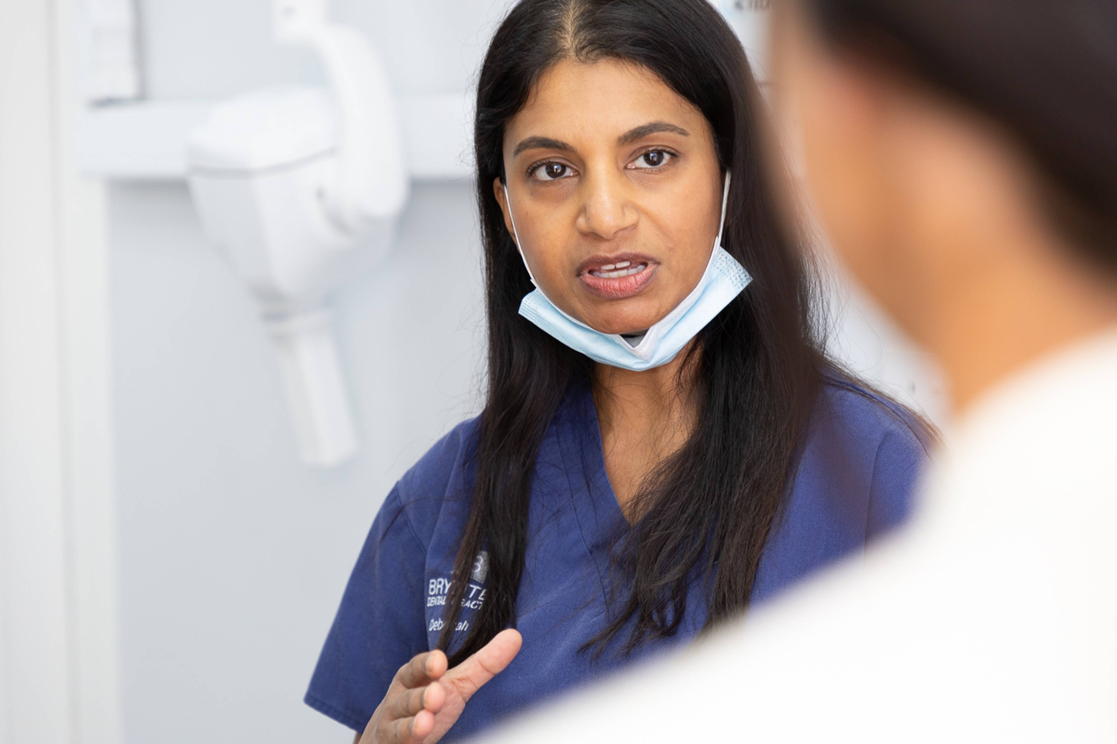 Clinician explaining teeth cleaning tools