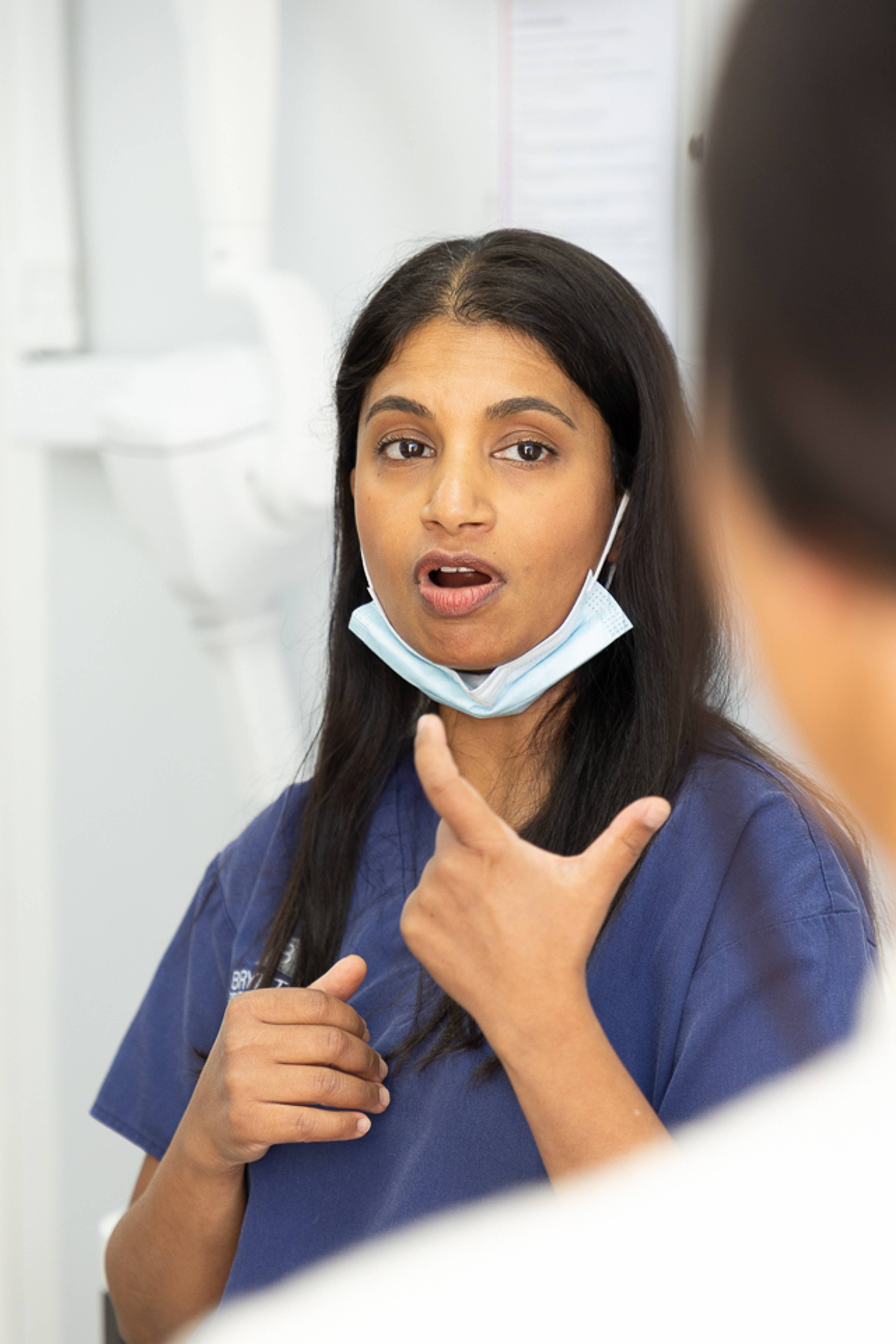 Dentist Deborah Rajaratnam explaining treatment