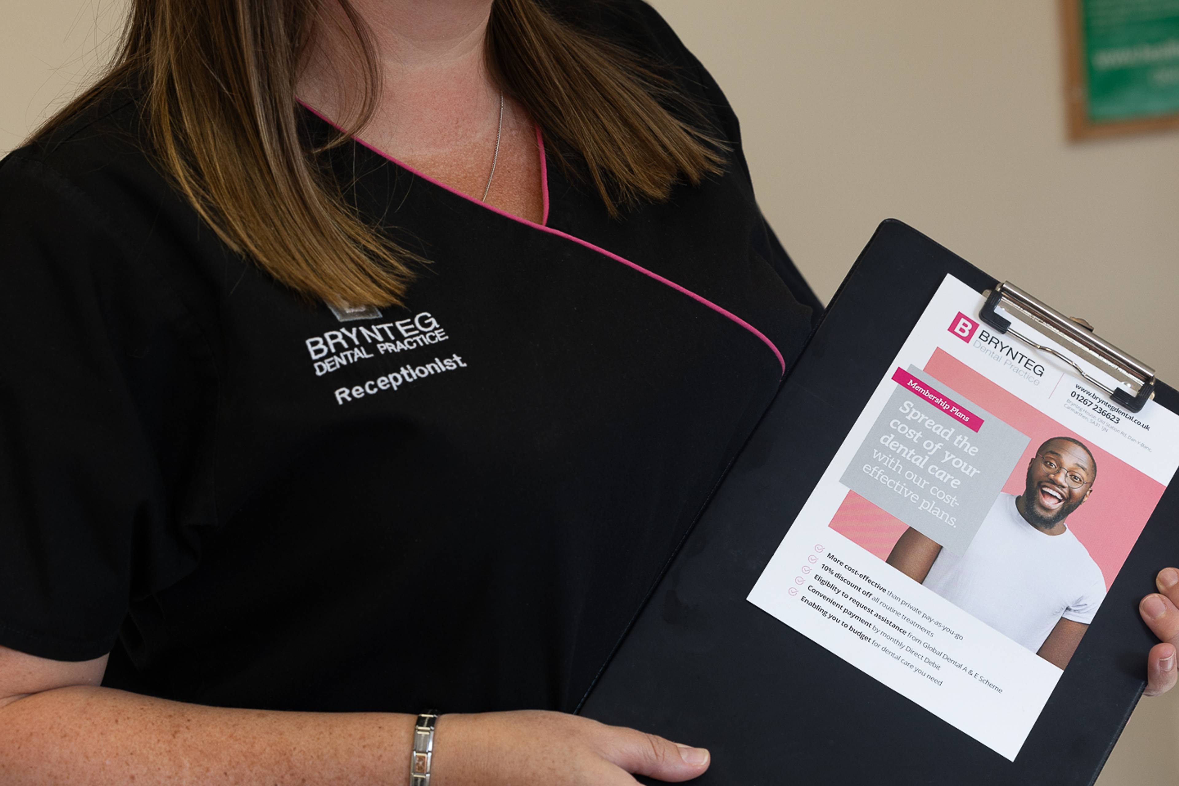 Reception staff showing Brynteg Dental membership plan