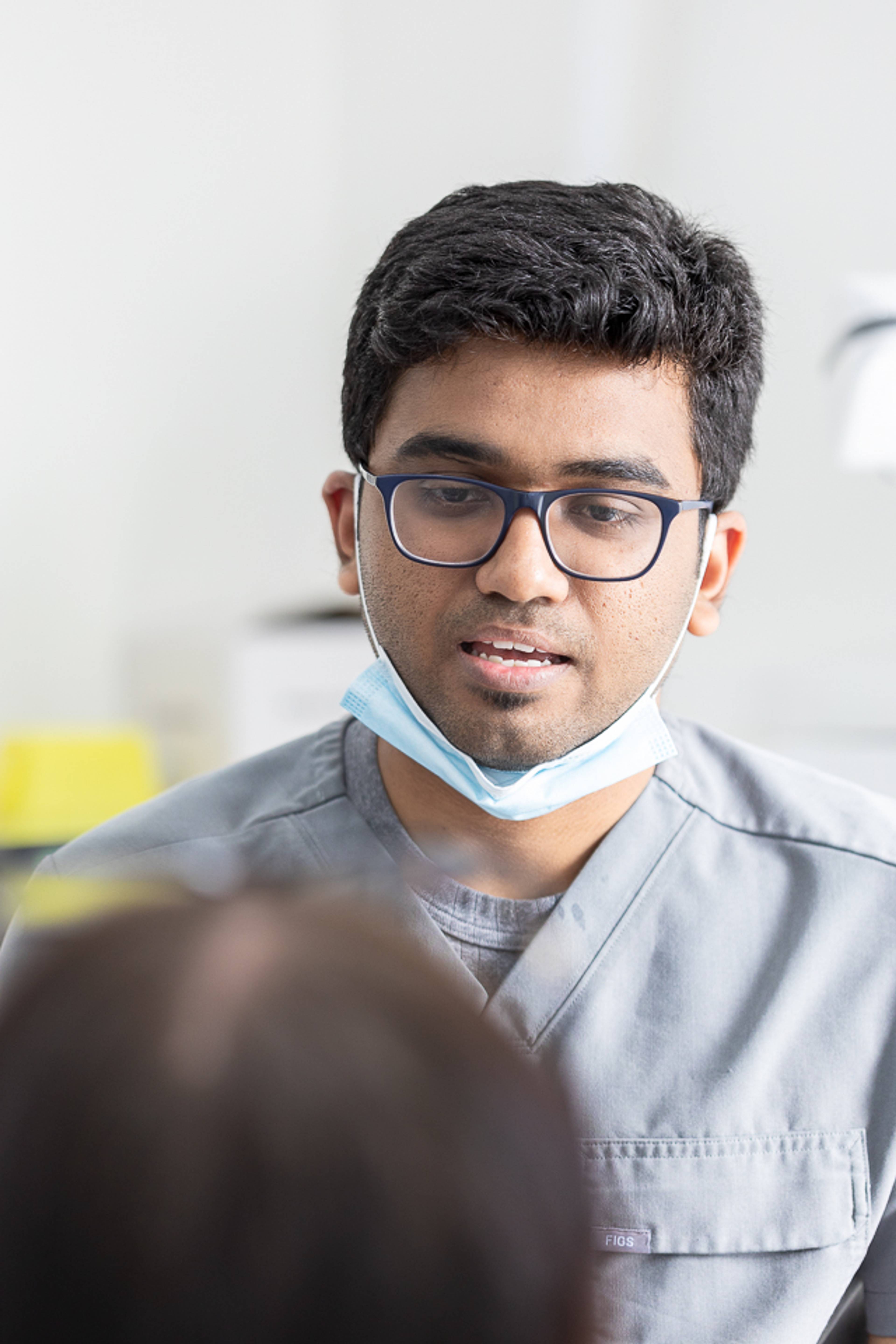 Dental therapist talking with patient